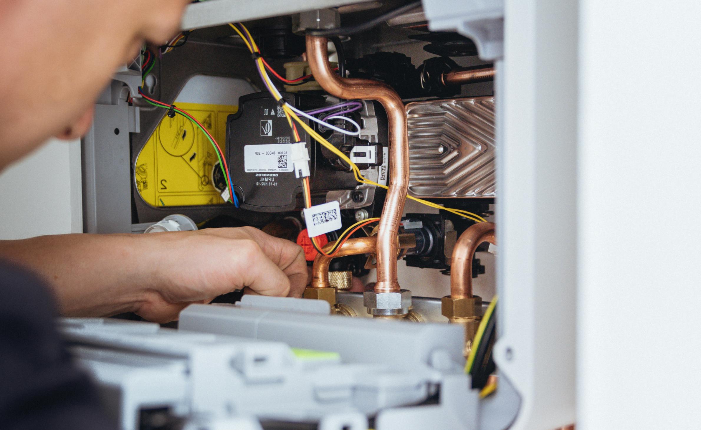 An engineer fixing a boiler