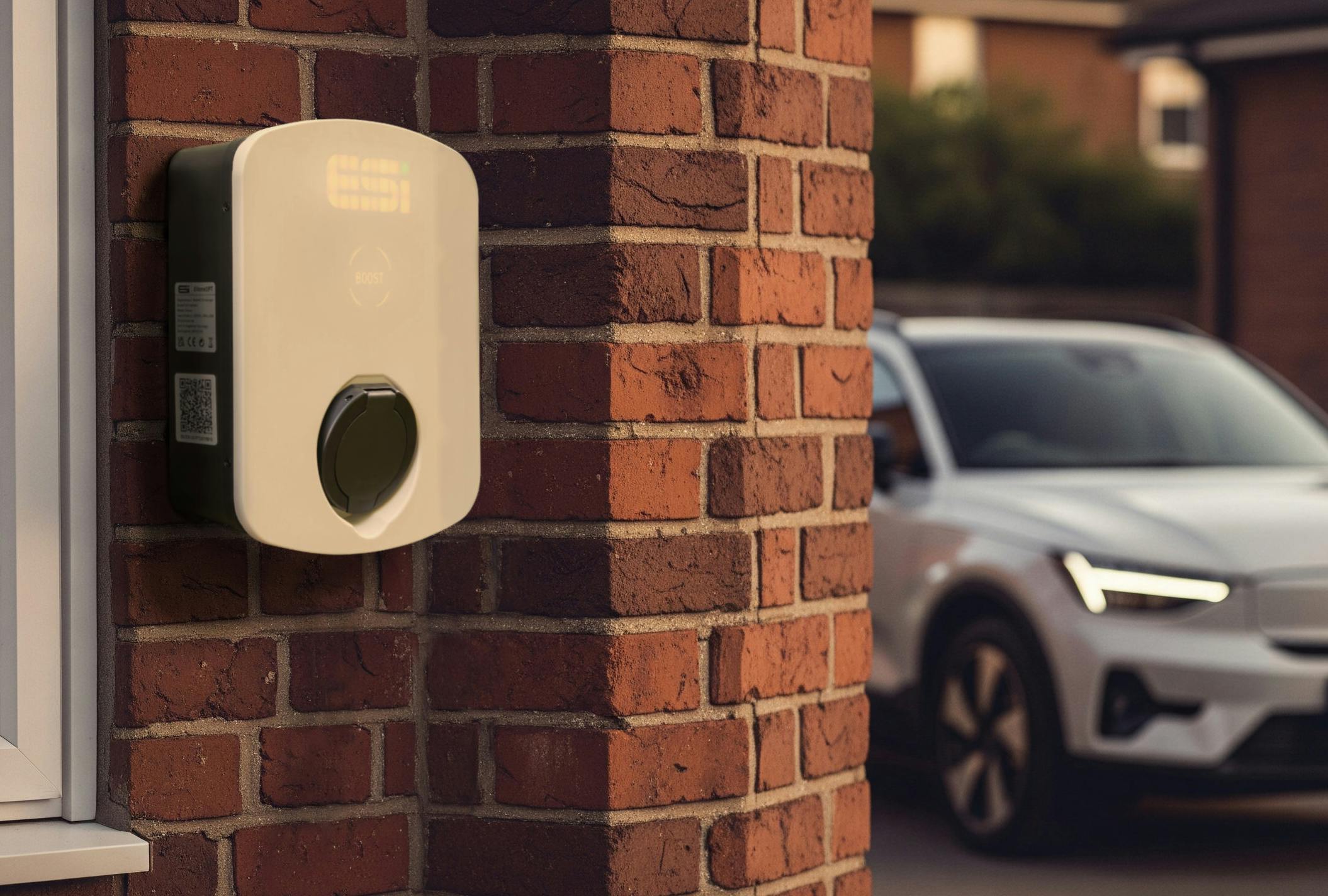 An ESi EV Charger with a car parked in the background