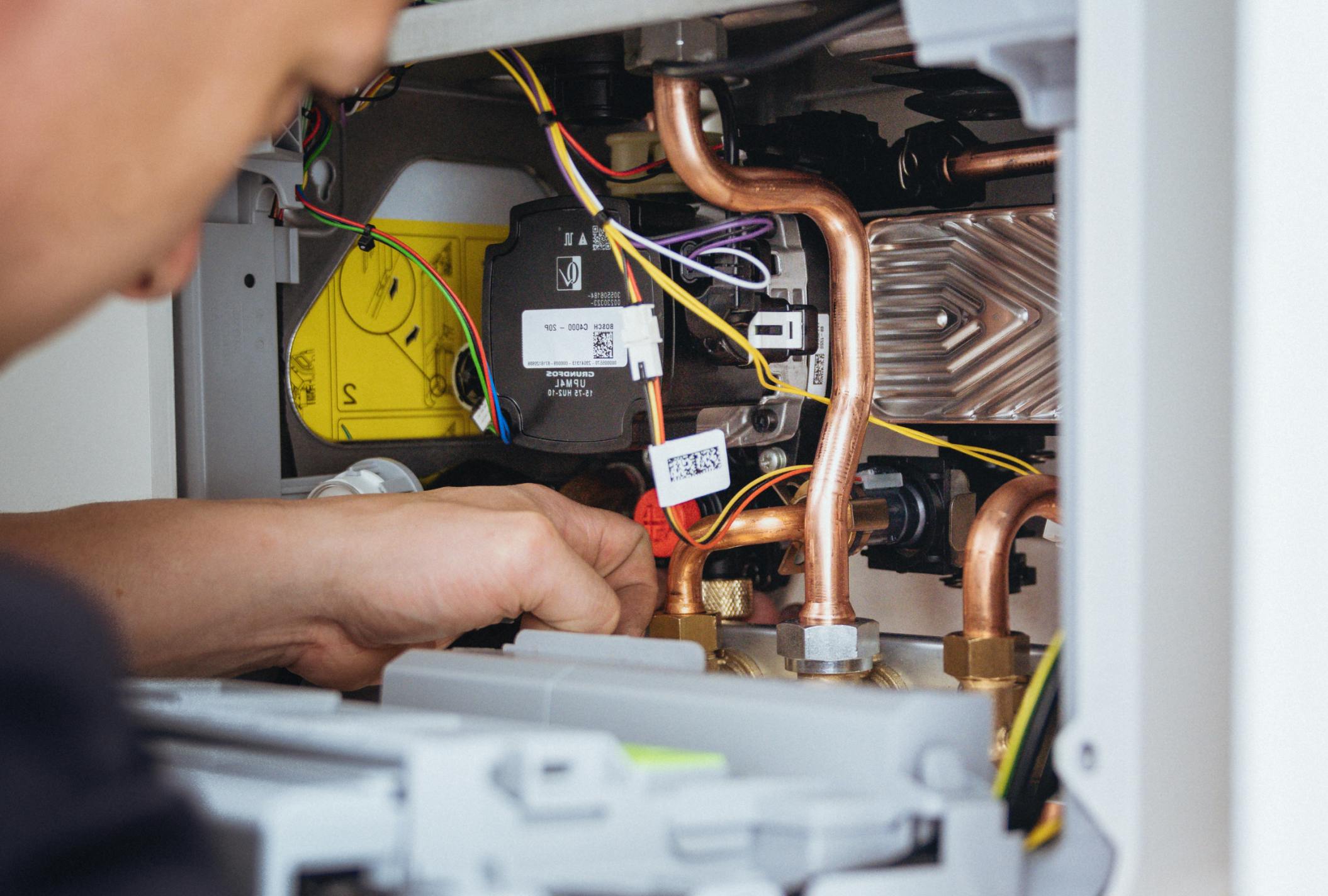 An engineer fixing a boiler