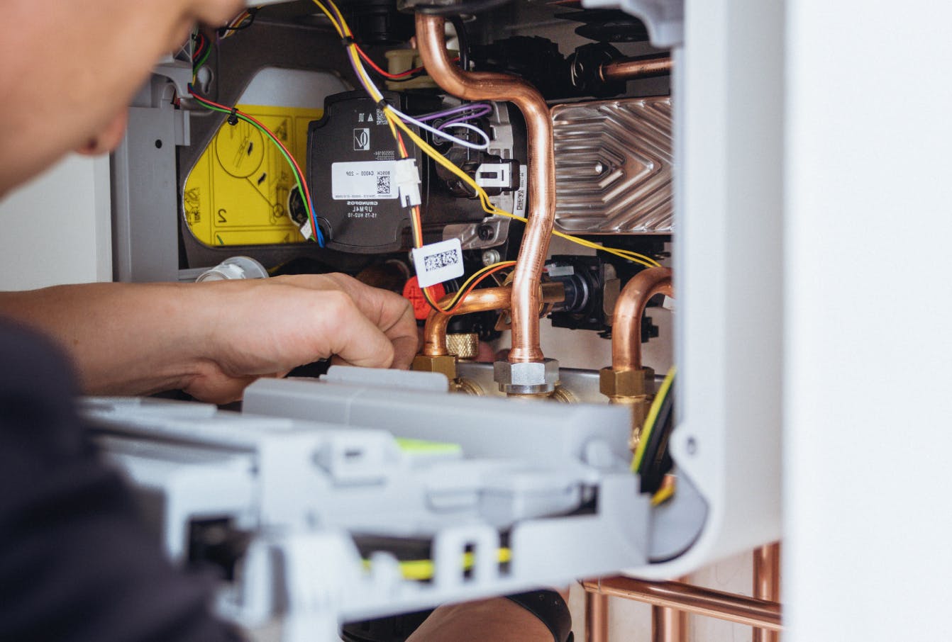 An engineer fixing a boiler
