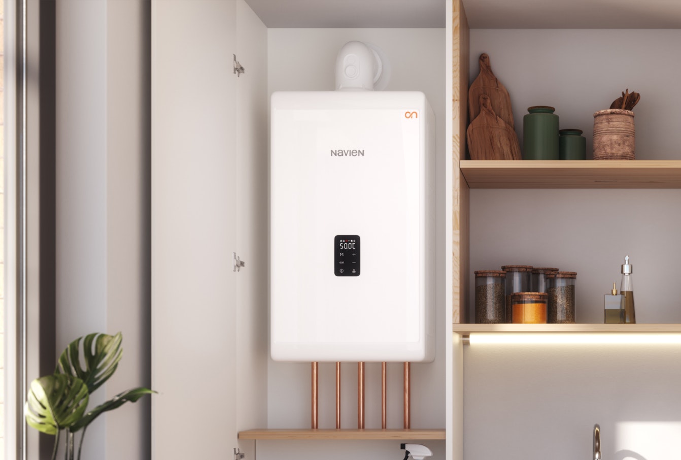 A Navien combi boiler installed in a kitchen cupboard