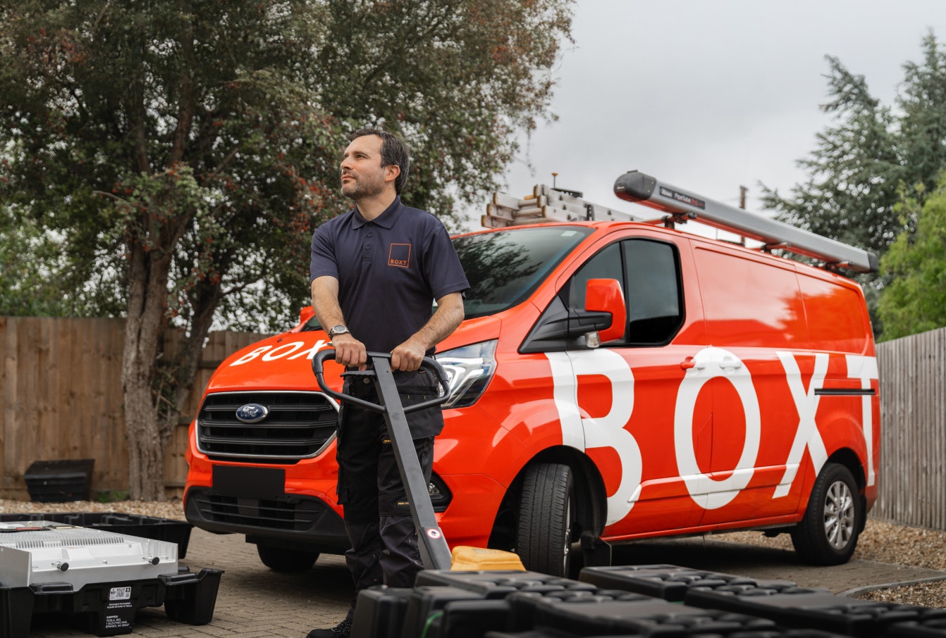 Engineer in front of a BOXT van with a battery on a palette truck