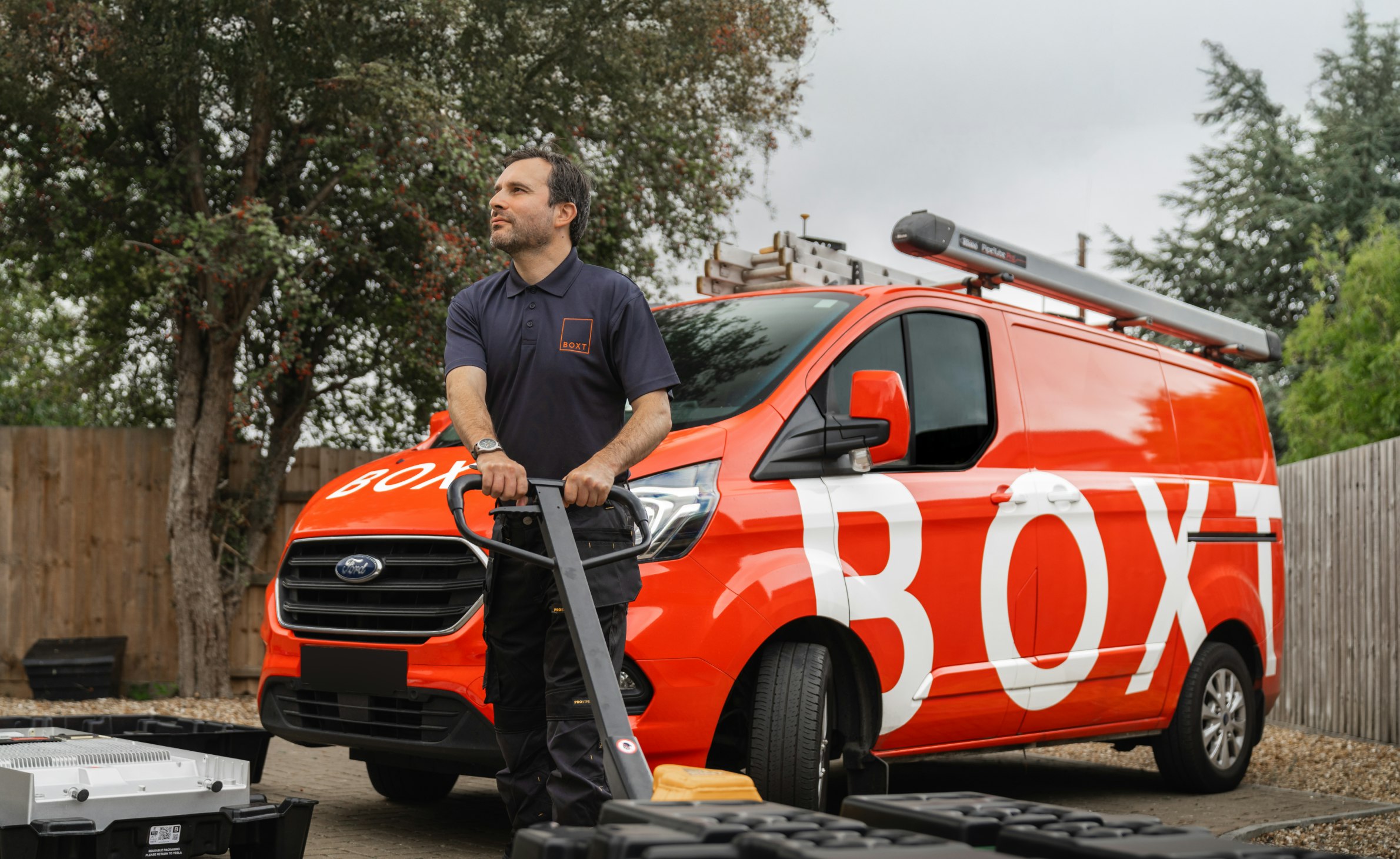 Engineer in front of a BOXT van with a battery on a palette truck