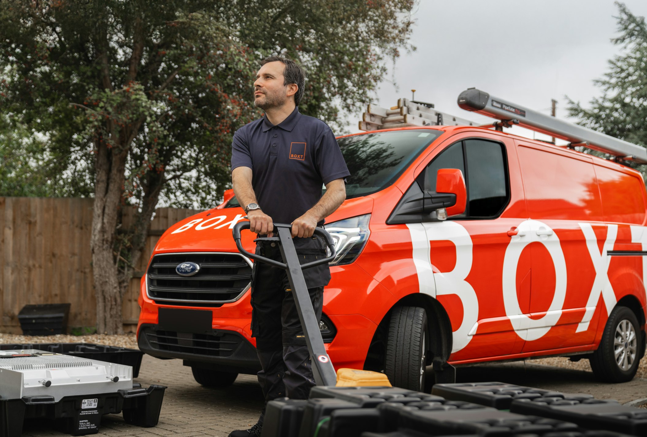 Engineer in front of a BOXT van with a battery on a palette truck