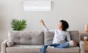 woman controlling the air conditioner